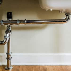 Close-up of water pipes under a sink