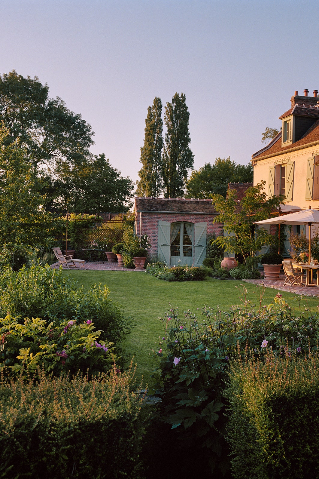 Image may contain Plant Grass Housing Building Tree and Outdoors