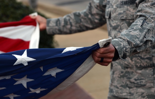 An Airman holds the U.S. flag during retreat on Maxwell Air Force Base, Ala., Jan. 26, 2017. All ALS students participate in reveille and retreat every day as part of their duties during the five-week leadership course. (U.S. Air Force photo/Senior Airman Tammie Ramsouer)