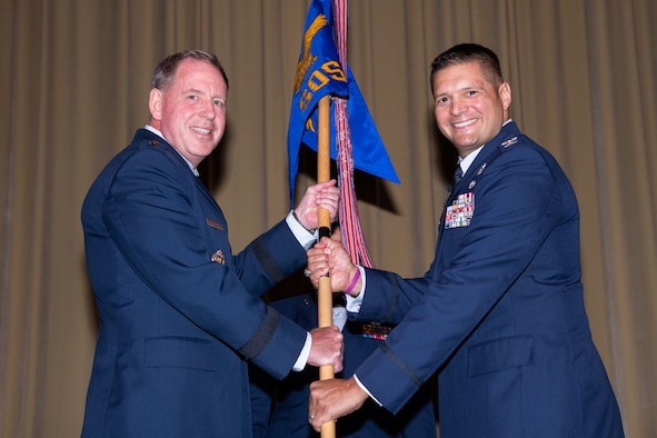 Maxwell AFB, Ala. - Lt Gen James Hecker commander and president, passes the unit guidon to incoming Squadron Officer School Commander Col. Lance Rosa-Miranda at the SOS Assumption of Command Ceremony held June 21, 2021, at Maxwell Air Force Base, Alabama. (U.S. Air Force photo by William Birchfield)