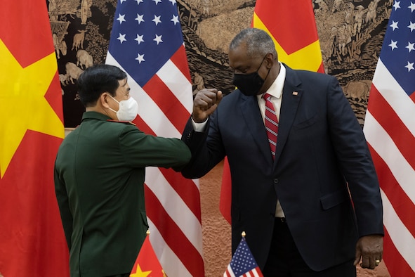 Secretary of Defense Lloyd J. Austin III and Vietnamese Defense Minister Phan Van Giang bump elbows after the signing the Vietnamese Wartime Accounting Initiative Memorandum of Understanding