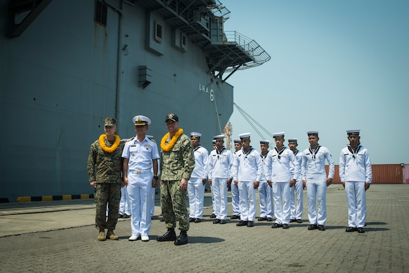 US and Thai military personnel pose in front of the USS America