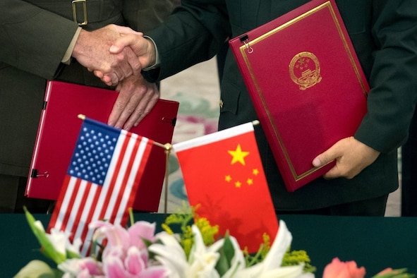 General Joseph Dunford (L), chairman of the US Joint Chiefs of Staff, and Chief of the General Staff of the Chinese People's Liberation Army General Fang Fenghui shake hands after signing an agreement