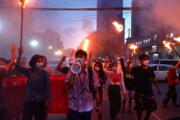 Protesters hold up the three-finger salute during a demonstration against the military coup in Yangon on July 29, 2021.