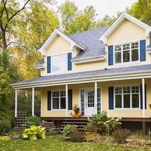 Yellow house surrounded by trees in autumn