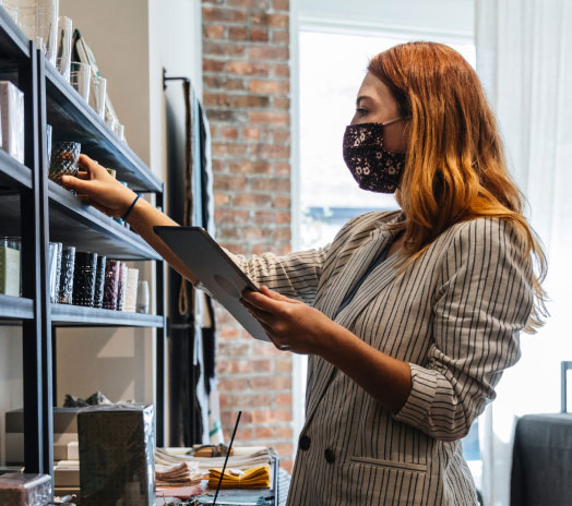 A woman with mask holding tablet