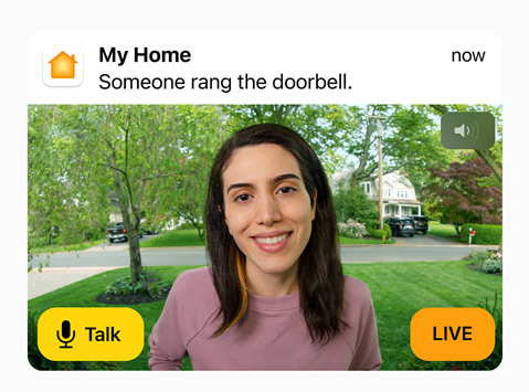 View of a doorbell camera shows a woman in a pink sweatshirt. The words “Talk” and “Live” are on screen.