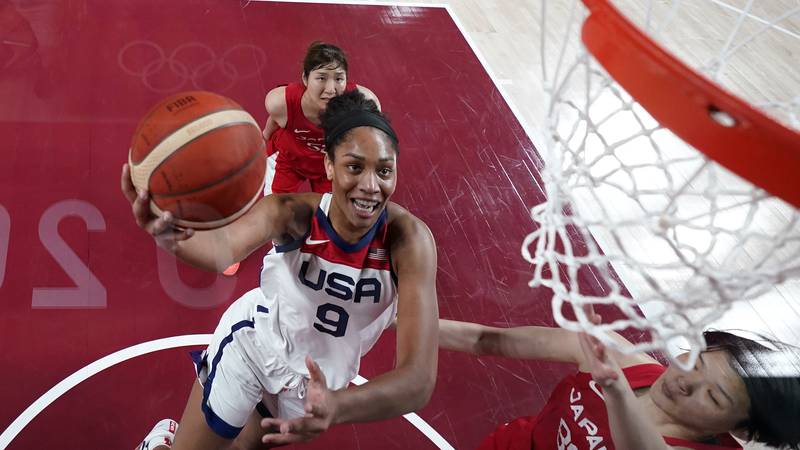 United States's A'Ja Wilson (9) drives past Japan's Himawari Akaho (88) during a women's gold...