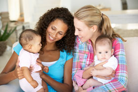 Two mothers holding their babies