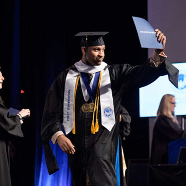 Graduate holding up diploma