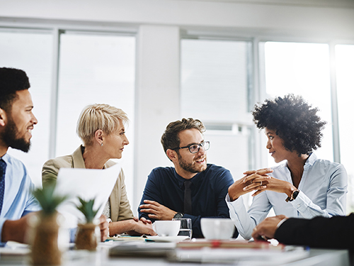 Colleagues sitting around a table in discussion