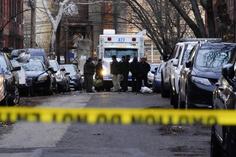 Officials gather by a response vehicle