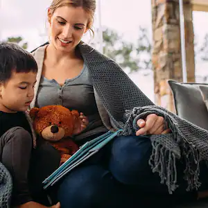 Mom and child read under blanket