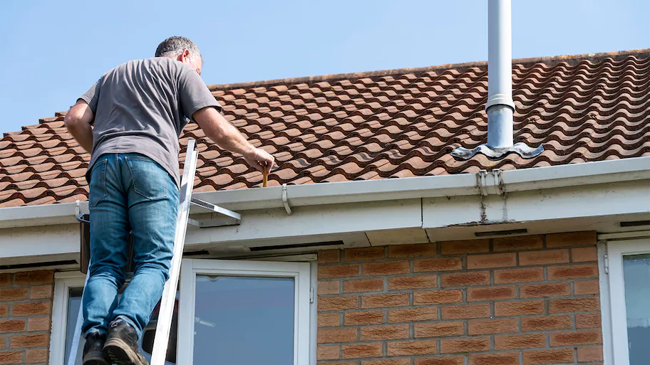 man cleaning roof