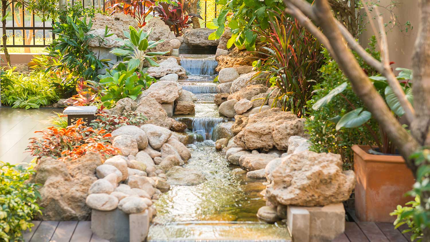 stone garden water fountain with plants