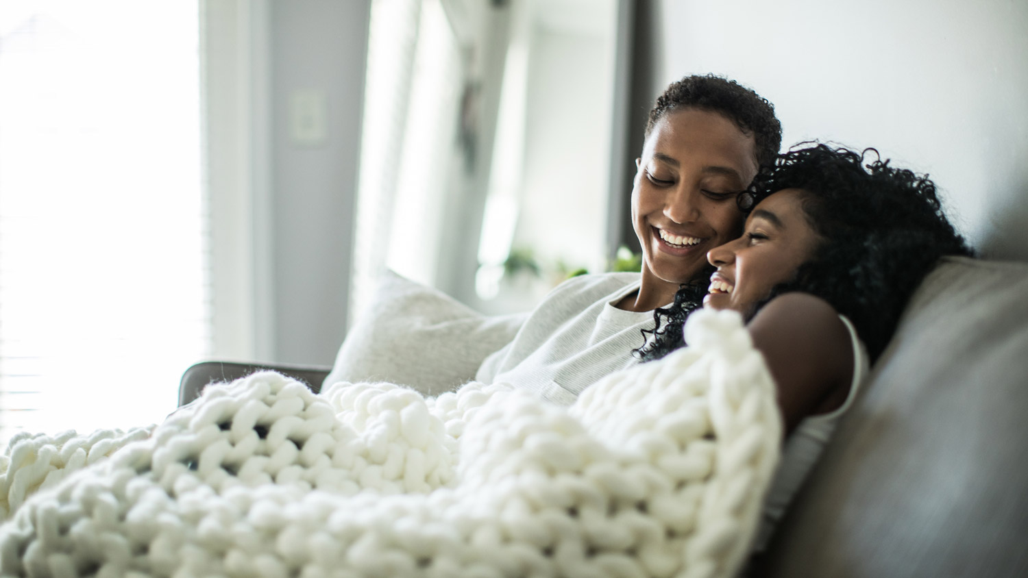 A couple covered in a blanket