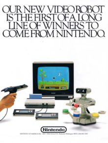 A gameplay diorama featuring an NES prototype with top-loaded Famicom cartridge, AVS style controllers, and R.O.B. It has the caption "Our new video robot is the first of a long line of winners to come from Nintendo".