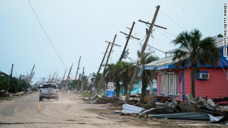 A motorist drives down a road in the wake of Hurricane Ida on September 4, 2021 in Grand Isle, Louisiana. 