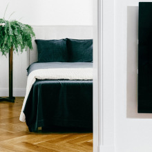 Black rectangular heater on wall in front of bedroom