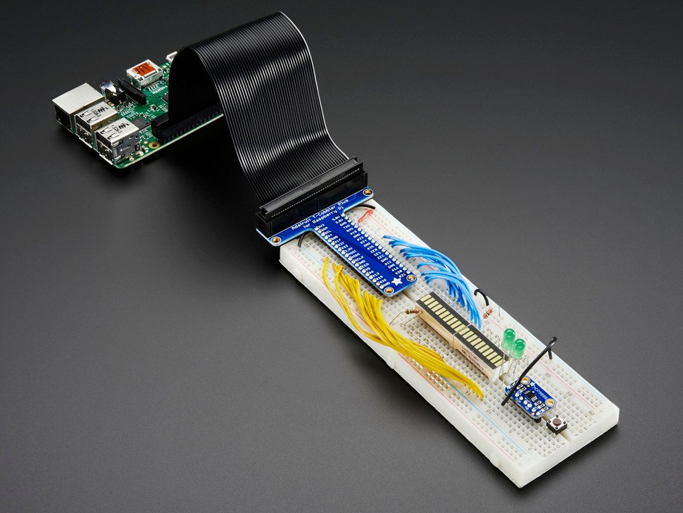 Angled shot of assembled Assembled Pi T-Cobbler Plus to a full-size populated breadboard connected via GPIO ribbon cable to a Raspberry Pi 3.