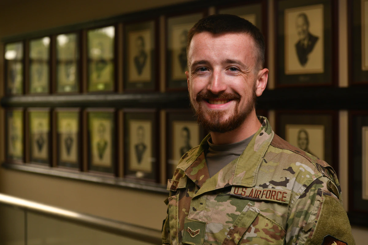 Airman 1st Class Braxton Comer, a student services technician with the Community College of the Air Force and practicing Norse Pagan, poses for a photo in the CCAF building on Maxwell-Gunter Annex, Alabama, July 27, 2021. Comer requested a religious accommodation waiver for the wear of a beard to express his religious beliefs and received approval in June 2021.