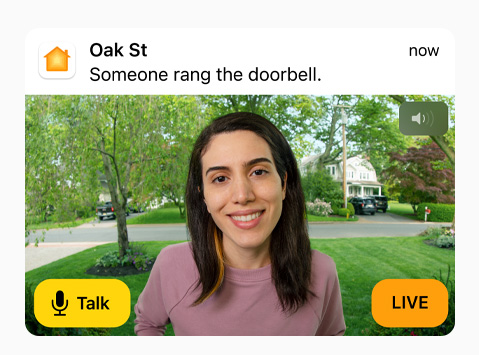 View of a doorbell camera shows a woman in a pink sweatshirt. The words “Talk” and “Live” are on screen.