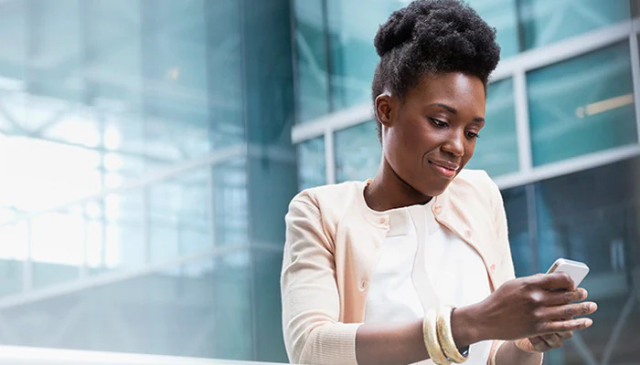 Person in an office looking at her cell phone