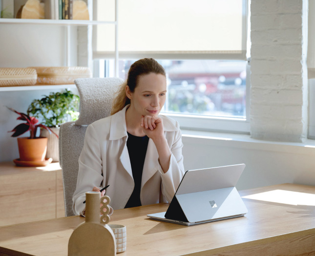 Person in an office using a tablet on a stand