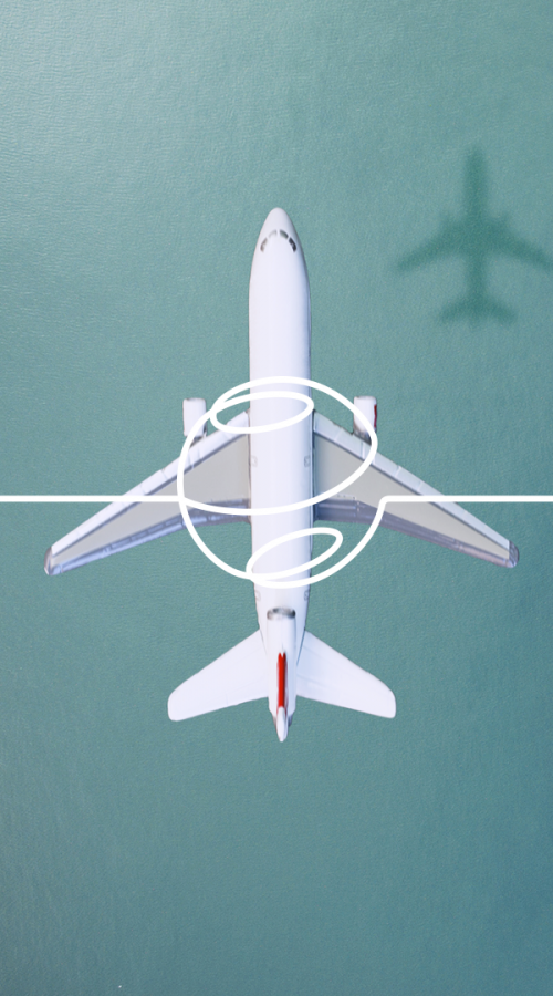 an airplane flies over a harbor with containers