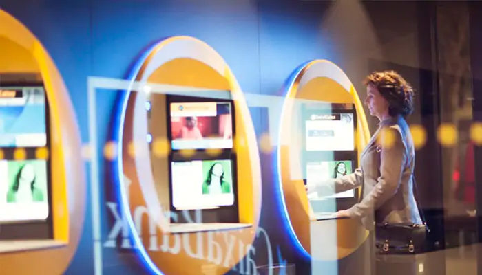 Woman standing in front of a bank ATM