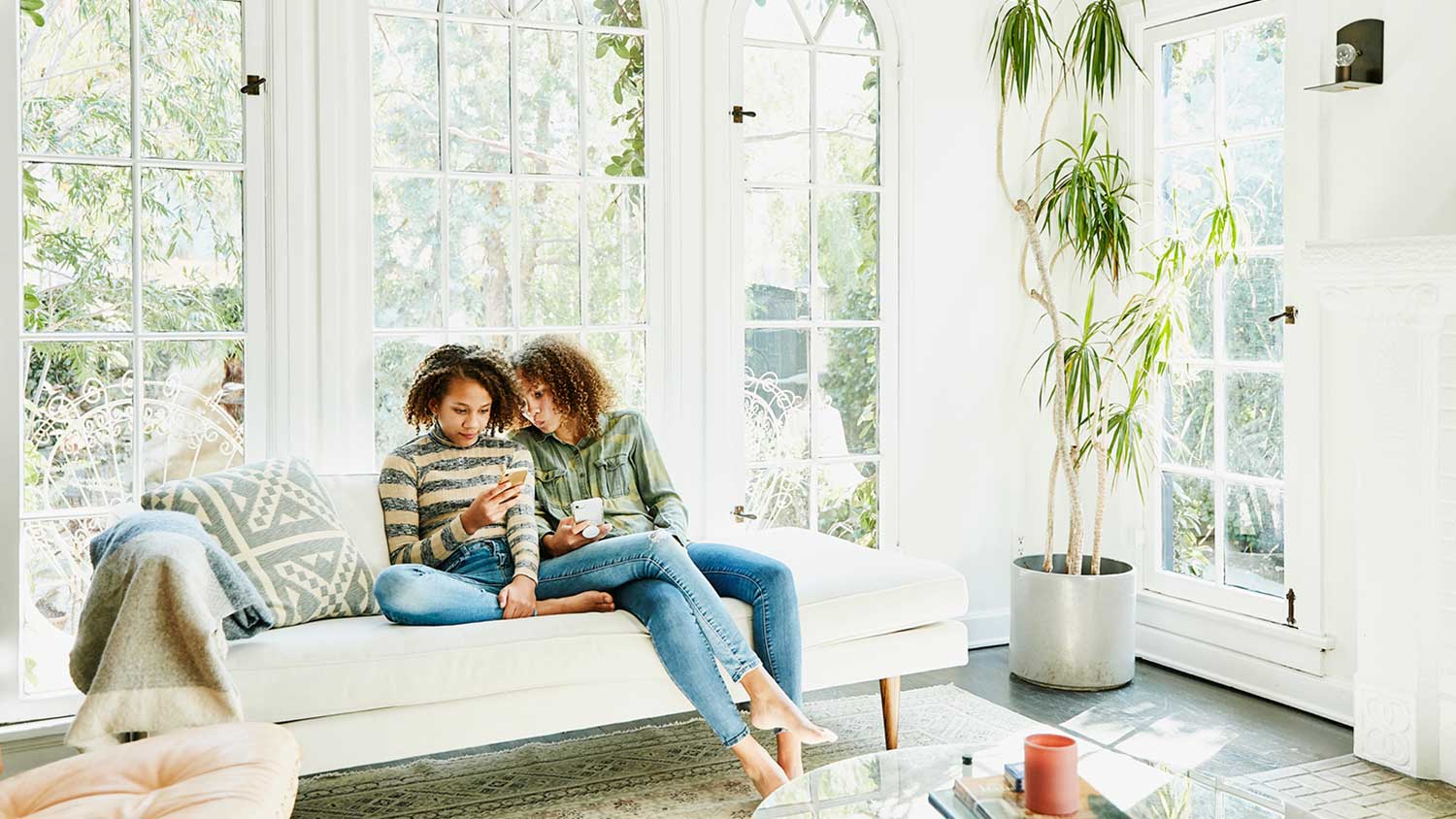 Sisters in a bright living room spending time together