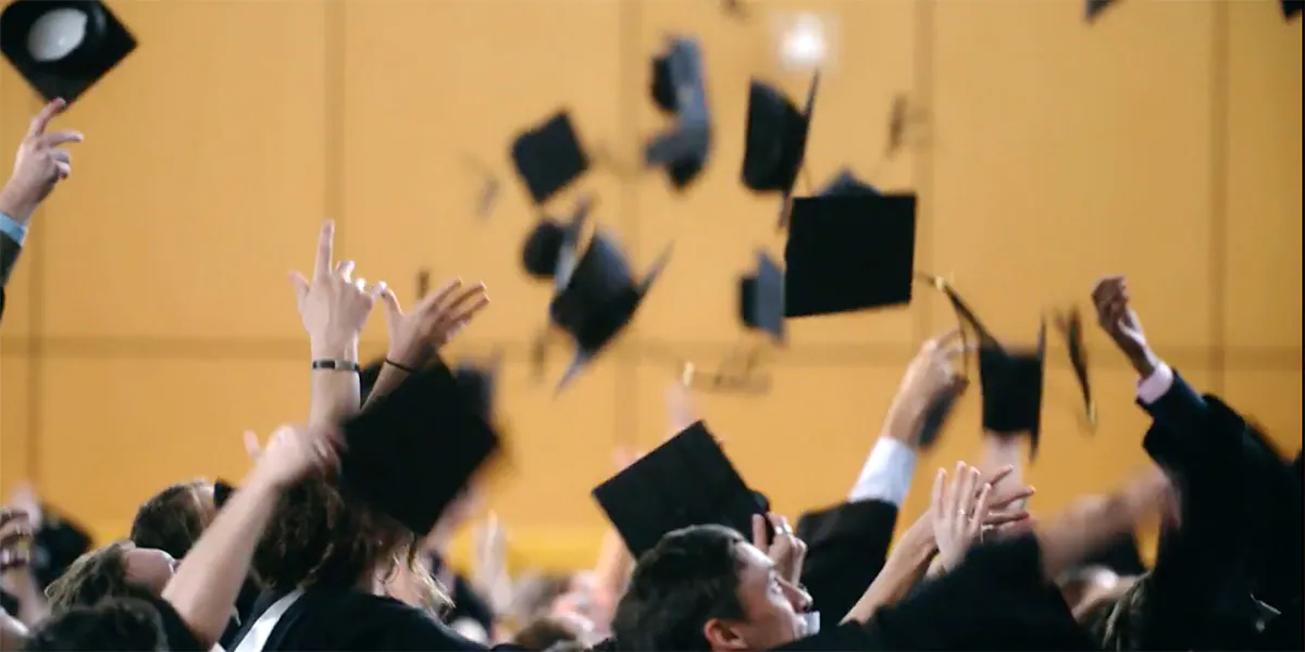 Graduating students throwing caps