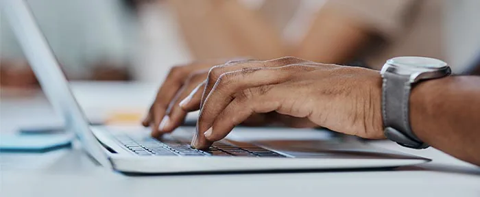 Hands on the keyboard of a notebook PC