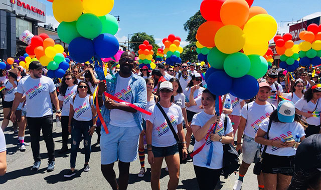 IBMer in shirt with rainbow logo of IBM