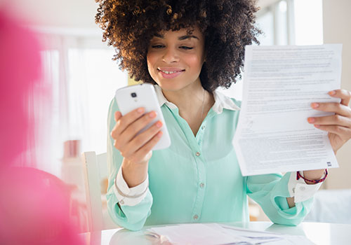 Woman in orange top with tablet