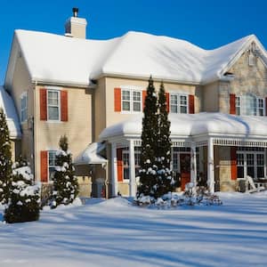 A house during winter all covered in snow