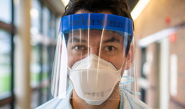 man wearing face mask and plastic face shield