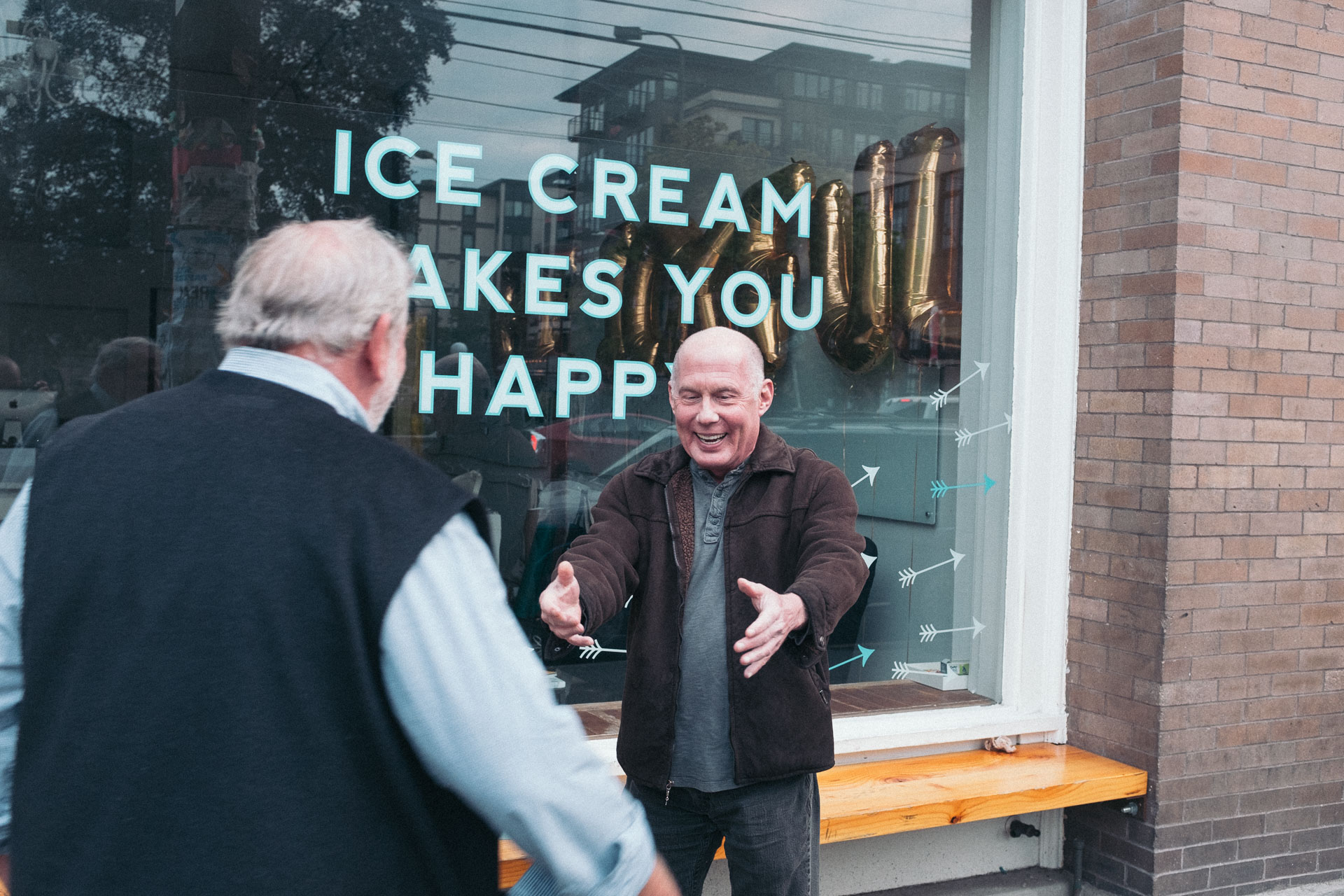 Two men in front of ice cream store