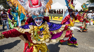 People dressed up in bright colored costumes in the carnival parades in Barranquilla, Colombia.