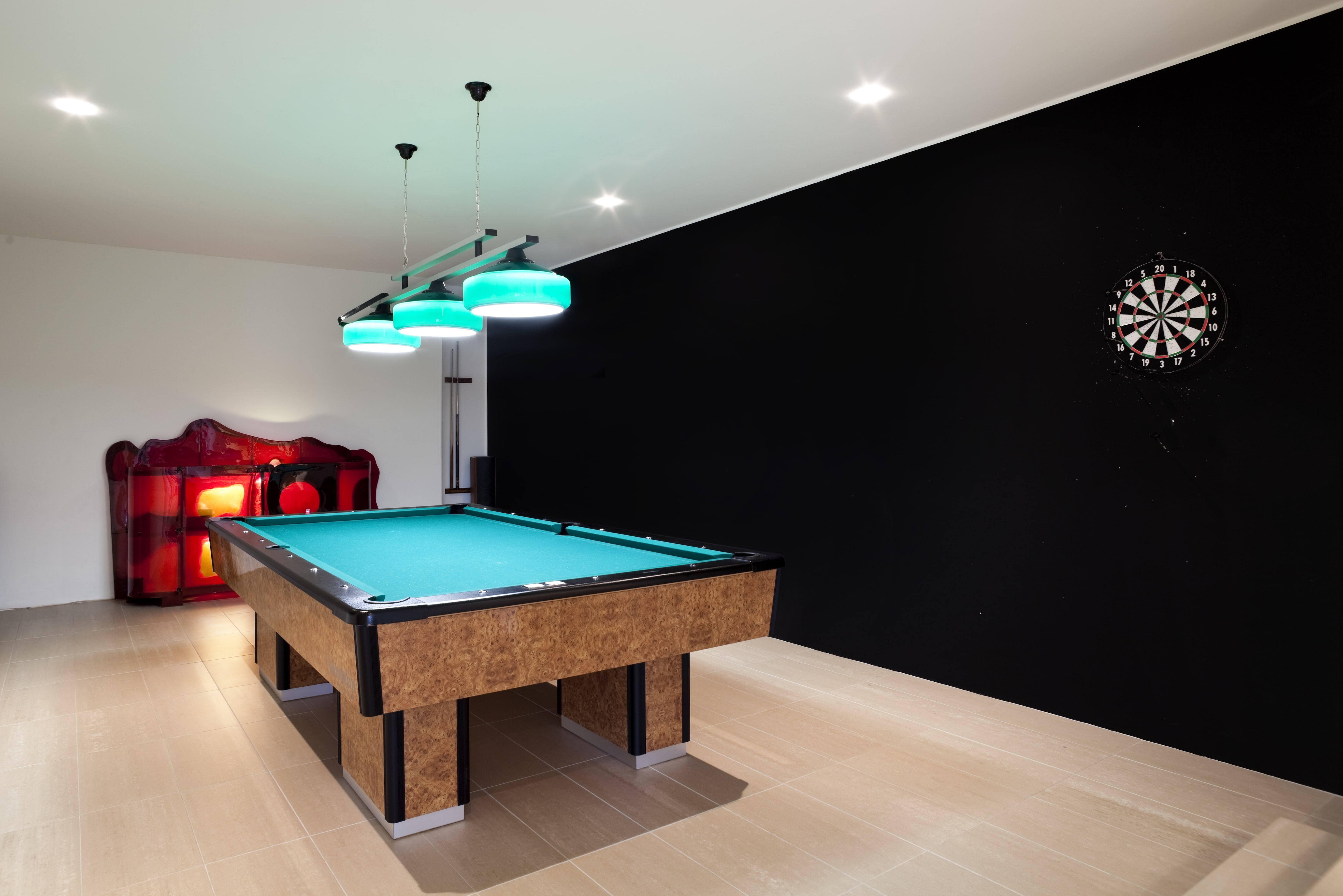 Pool table and dart board in basement