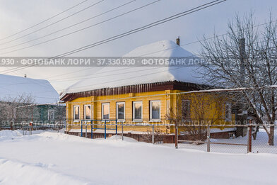 Large wooden house in the village in winter