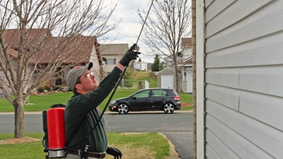 Larry Rufledt Jr. of Westside Pest Solutions in Hanover, Minnesota, sprays a home for a pest control problem. (Photo by John Molene)