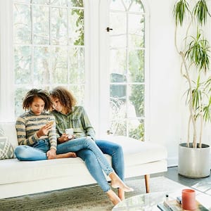 Sisters in a bright living room spending time together