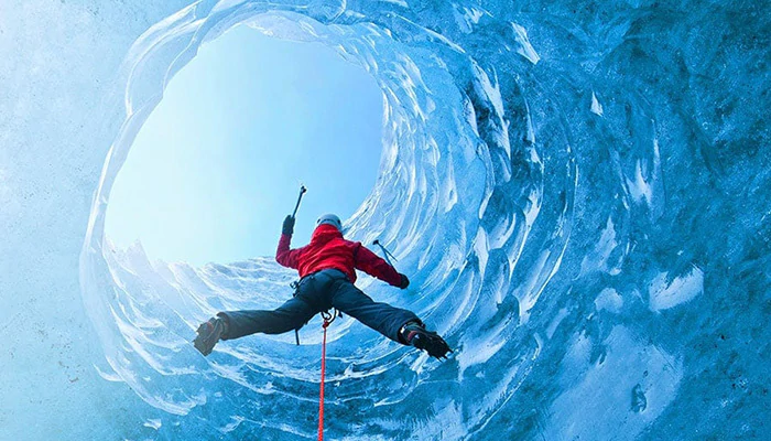 Person climbing ice cliff