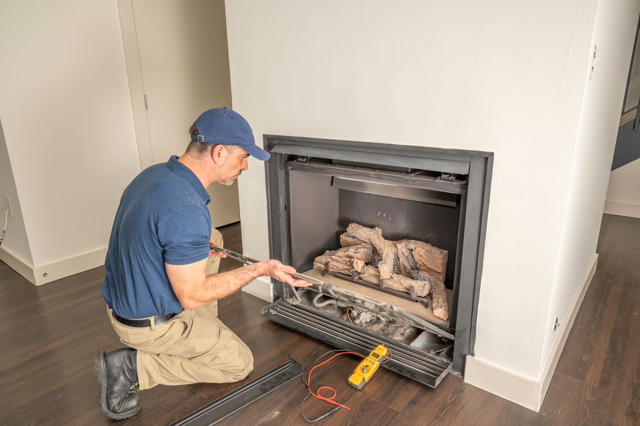 man installing fireplace