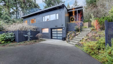 Asphalt driveway leading up to a two-story contemporary home