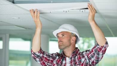 Man installing suspended ceiling  