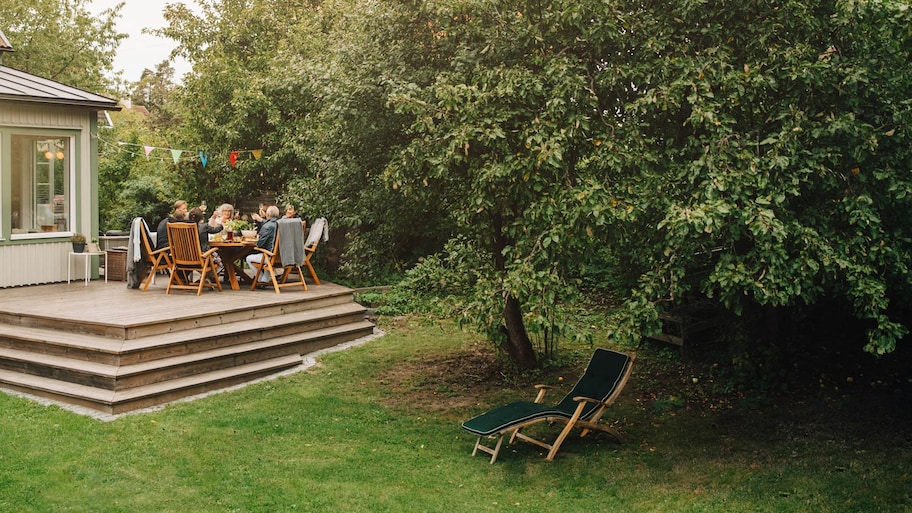 Family and friends enjoying their dinner in the backyard