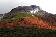 Image of volcanic steam rising from a mountaintop