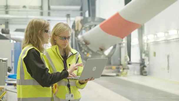 Two people with laptop in factory